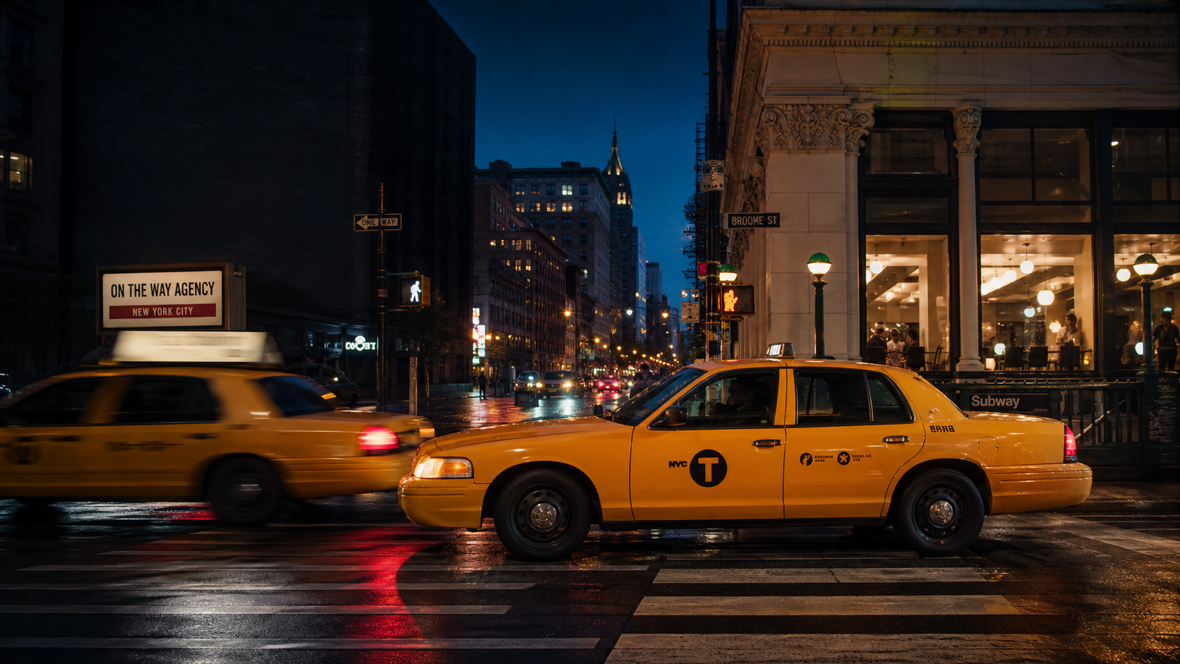 Yellow taxis moving through a New York City street at night